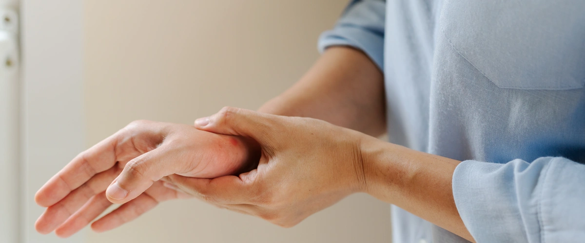 starsza kobieta trzyma się za rękę