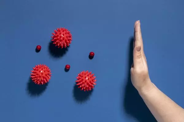 ilustracja przedstawiająca ręke zatrzymująca wirusy