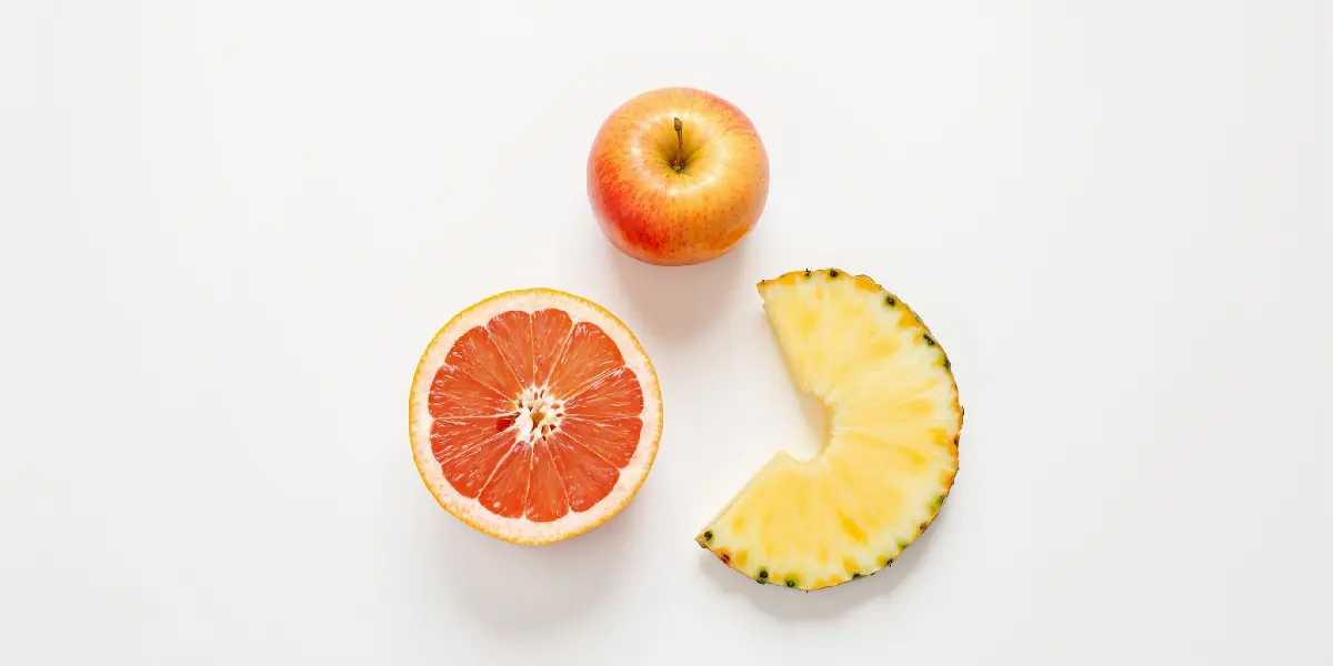połówka grejpfruta, plaster ananasa i jabłko