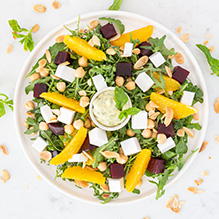 dinner in a vegan box diet - salad with arugula, caramelized beetroot, vegan cheese, chickpeas, orange and mint dressing
