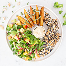 dinner in a vegan box diet - seitan nuggets in sesame coating, baked potatoes with thyme, salad with nectarine, avocado and peanut sauce