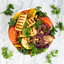 dinner in a vegetarian box diet - bowl with grilled halloumi cheese, roasted vegetables, chickpeas and kale
