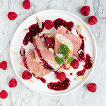breakfast in a vegetarian box diet - pancakes with apricot cottage cheese, raspberry mousse and roasted coconut flakes