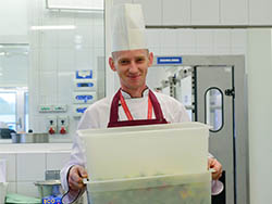 Employee of wygodnadieta dietary catering company carrying the food
