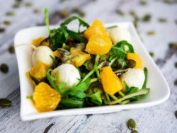 Mixed salad with mozzarella, orange and pumpkin seeds, dietary catering in Poznan